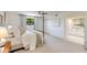 Bright bedroom featuring soft carpet, a four-poster bed, a ceiling fan and a modern bathroom at 3020 E Mission Ln, Phoenix, AZ 85028