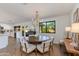 Stylish dining area with modern chandelier, table for six and easy access to the kitchen at 3020 E Mission Ln, Phoenix, AZ 85028