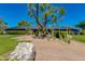 Charming exterior showcasing lush landscaping, mature trees, and a well-maintained lawn at 3020 E Mission Ln, Phoenix, AZ 85028
