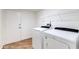 Bright white laundry room featuring modern washer and dryer and a wire rack at 3020 E Mission Ln, Phoenix, AZ 85028