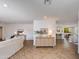 Bright, open-concept living area with light wood floors and stylish neutral furniture at 3020 E Mission Ln, Phoenix, AZ 85028