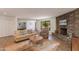 Bright living room with stone fireplace, wood floors, and sliding doors leading to the exterior at 3020 E Mission Ln, Phoenix, AZ 85028