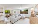 Open-concept living space with large windows, modern furniture, and inviting atmosphere at 3020 E Mission Ln, Phoenix, AZ 85028
