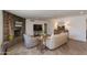 Open living room features a stone fireplace, wood floors and neutral furnishings at 3020 E Mission Ln, Phoenix, AZ 85028