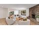 Living room featuring stone fireplace, large sofa and comfortable seating at 3020 E Mission Ln, Phoenix, AZ 85028