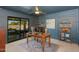Home office with dark blue wall paneling, outdoor access and views of the pool at 3020 E Mission Ln, Phoenix, AZ 85028