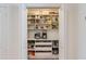 Walk-in pantry with organized shelving and drawers offers ample storage space for groceries and kitchen essentials at 3020 E Mission Ln, Phoenix, AZ 85028