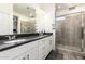 Bright bathroom featuring double sinks with granite counters and a glass shower at 3231 S Mingus Dr, Chandler, AZ 85286