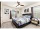 Bedroom featuring a queen bed, ceiling fan and natural light from the large window at 3231 S Mingus Dr, Chandler, AZ 85286
