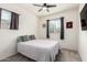Bright bedroom featuring a ceiling fan, two windows, and neutral-toned furnishings at 3231 S Mingus Dr, Chandler, AZ 85286