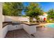 Outdoor grill area featuring a stainless steel grill, counter space, and brick flooring at 3231 S Mingus Dr, Chandler, AZ 85286