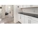Hallway with white cabinets and black countertops providing extra storage space at 3231 S Mingus Dr, Chandler, AZ 85286