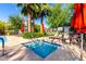 Relaxing community hot tub surrounded by lounge chairs, lush landscaping, and shade umbrellas at 3231 S Mingus Dr, Chandler, AZ 85286