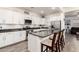 Well-appointed kitchen features stainless steel appliances, granite countertops, white cabinets, and breakfast bar at 3231 S Mingus Dr, Chandler, AZ 85286