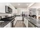 Modern kitchen featuring stainless steel appliances, granite countertops and white cabinets at 3231 S Mingus Dr, Chandler, AZ 85286