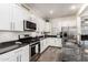 Bright kitchen features stainless steel appliances, granite countertops and white cabinets at 3231 S Mingus Dr, Chandler, AZ 85286