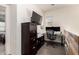 Functional home office with desk, multiple monitors, built-in storage and vinyl flooring at 3231 S Mingus Dr, Chandler, AZ 85286