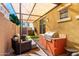Relaxing covered patio featuring an outdoor grill, ample seating, and well-maintained pavers at 3231 S Mingus Dr, Chandler, AZ 85286