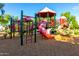 Colorful community playground with slides, climbing structures, and a wood chip ground cover at 3231 S Mingus Dr, Chandler, AZ 85286