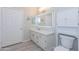 Well-lit bathroom featuring a vanity, white cabinets, and an LED mirror above the sink at 3236 E Chandler Blvd # 3031, Phoenix, AZ 85048