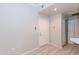 Bright entryway with a white door, light wood-look flooring, and access to a coat closet at 3236 E Chandler Blvd # 3031, Phoenix, AZ 85048