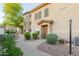 Exterior view of the condo building with a well-maintained front garden and desert landscaping at 3236 E Chandler Blvd # 3031, Phoenix, AZ 85048