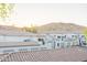 View of condo complex with Spanish tile roofs on landscaped grounds at 3236 E Chandler Blvd # 3031, Phoenix, AZ 85048