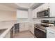 Modern kitchen with stainless steel appliances, white cabinets, and quartz countertops at 3236 E Chandler Blvd # 3031, Phoenix, AZ 85048