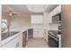 Bright kitchen features modern appliances, white cabinets, and light wood flooring at 3236 E Chandler Blvd # 3031, Phoenix, AZ 85048