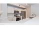 Contemporary kitchen featuring white cabinets, stainless steel appliances, and quartz countertops at 3236 E Chandler Blvd # 3031, Phoenix, AZ 85048