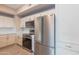 View of the stainless steel refrigerator and oven in the kitchen with white cabinets at 3236 E Chandler Blvd # 3031, Phoenix, AZ 85048