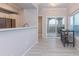 Open-concept living space flowing into the kitchen with a bar top, stainless appliances, and a balcony at 3236 E Chandler Blvd # 3031, Phoenix, AZ 85048