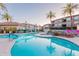 Beautiful community pool area with palm trees, lounge chairs, and lush landscaping at 3236 E Chandler Blvd # 3031, Phoenix, AZ 85048