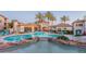 Community pool featuring a rock waterfall, adjacent buildings and resort-style furniture at 3236 E Chandler Blvd # 3031, Phoenix, AZ 85048
