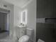 Modern bathroom with a gray-toned vanity, updated fixtures, and a gray tiled accent wall at 344 E Jacaranda St, Mesa, AZ 85201