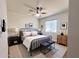 Well-lit bedroom with contemporary decor, a ceiling fan, and a view from the window at 344 E Jacaranda St, Mesa, AZ 85201