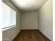 Sunlit bedroom featuring wood-look flooring and a large window with blinds at 344 E Jacaranda St, Mesa, AZ 85201