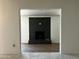 Living room with a modern black brick fireplace and updated hardwood-style flooring at 344 E Jacaranda St, Mesa, AZ 85201