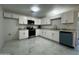 Bright kitchen with white cabinets, stainless steel appliances, and marble patterned floors at 344 E Jacaranda St, Mesa, AZ 85201