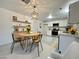 Bright eat-in kitchen featuring white cabinetry, stainless steel appliances, and light-filled dining area at 344 E Jacaranda St, Mesa, AZ 85201