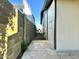 Side yard with concrete walkway, block fence, and view of the home's exterior siding at 344 E Jacaranda St, Mesa, AZ 85201