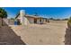 Expansive backyard featuring a covered patio and low-maintenance gravel landscaping, fully enclosed by a block wall for privacy at 4121 W Paradise Dr, Phoenix, AZ 85029