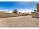 Spacious backyard featuring gravel landscaping, a wall, and a covered patio at 4121 W Paradise Dr, Phoenix, AZ 85029