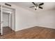 Spacious bedroom featuring modern ceiling fan and wood-look flooring, adding warmth and style at 4121 W Paradise Dr, Phoenix, AZ 85029