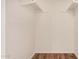 Walk-in closet featuring wooden floors and clothing rods on shelves at 4121 W Paradise Dr, Phoenix, AZ 85029