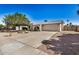 Exterior shot of a home with a spacious driveway, desert landscaping, and an attached two-car garage at 4121 W Paradise Dr, Phoenix, AZ 85029