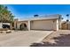 Exterior view of home featuring desert landscaping, two car garage, and a front porch at 4121 W Paradise Dr, Phoenix, AZ 85029