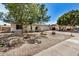 Exterior view of a home with drought tolerant landscaping, a front porch, and a two-car garage at 4121 W Paradise Dr, Phoenix, AZ 85029