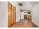 Hallway featuring wood-look floors and built in cabinets leading to the kitchen at 4121 W Paradise Dr, Phoenix, AZ 85029