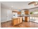Kitchen with wood-look flooring, light cabinets, and center island cooktop at 4121 W Paradise Dr, Phoenix, AZ 85029